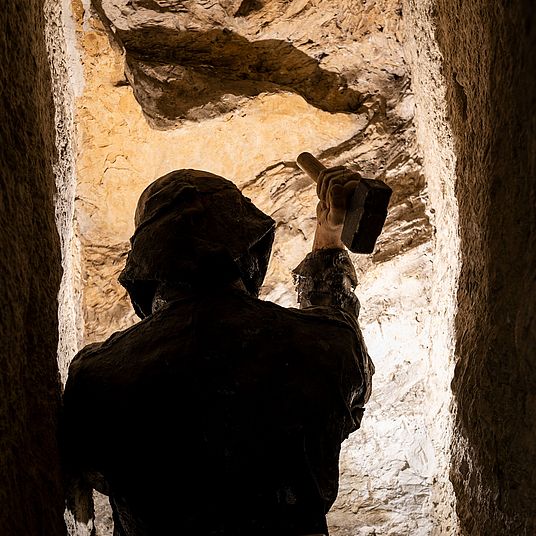 Ore extraction with a hammer and pick.