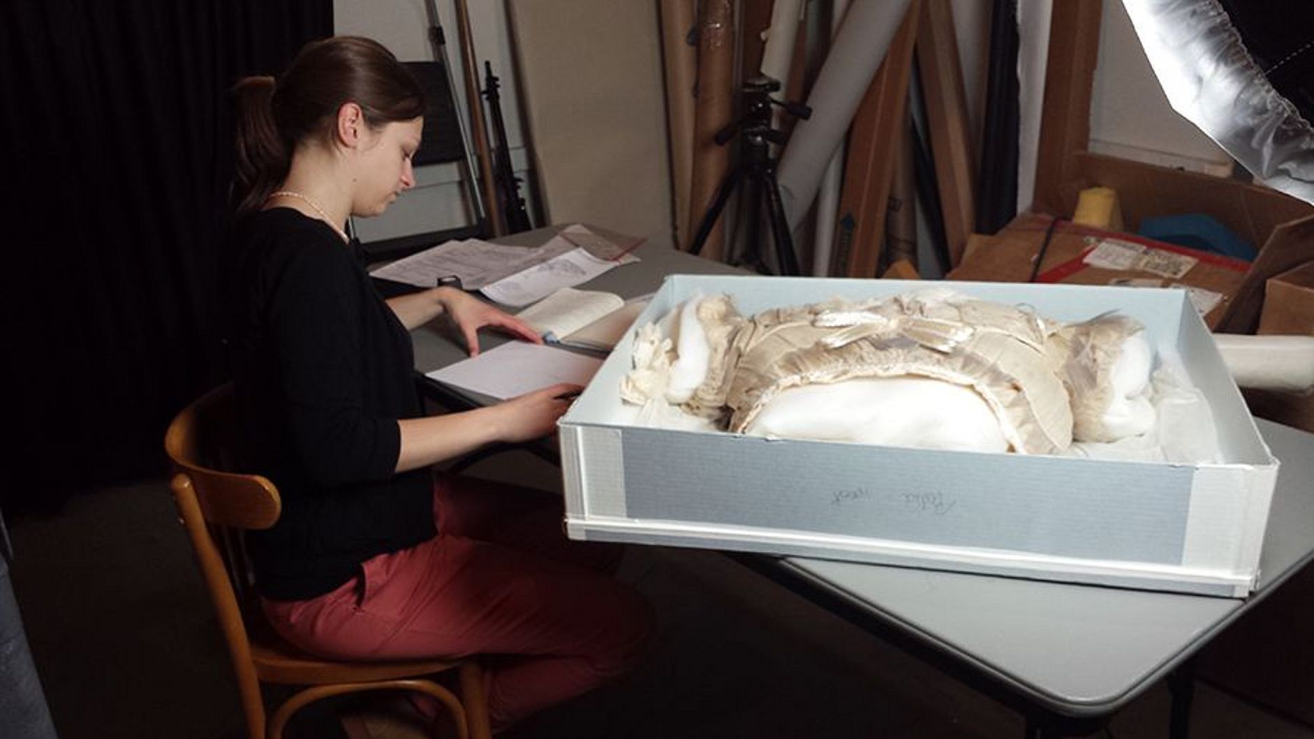 Charlotte Holzer bei der Untersuchung des Oberteils des Glasfaserkleids.