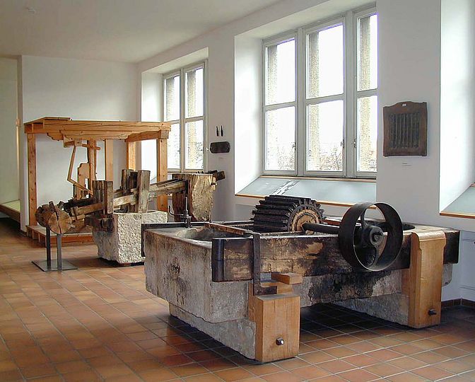 Blick in die Ausstellung Papiertechnik mit einem sogenannten "Holländer" zur Papierherstellung im Vordergrund.