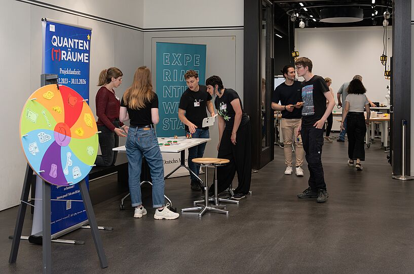 Menschen im Museum mit bunter Drehscheibe