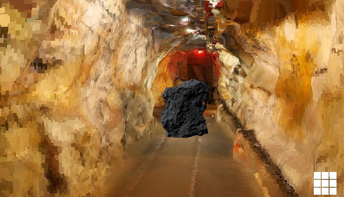 Ein Erzklumpen fliegt in einer animierten Bergwerksumgebung durch einen Stollen.