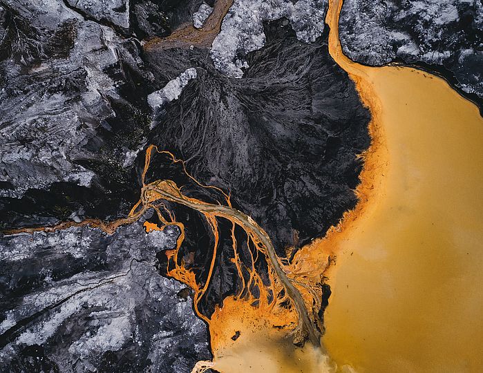 Das Bild zeigt orange gefärbtes Wasser rund um ein Kohlebergerwerk in Ostdeutschland.
