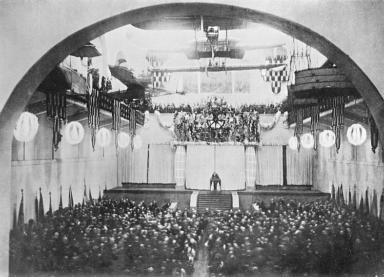 Oskar von Miller hält in der bestuhlten Schifffahrt- und Luftfahrthalle eine Rede bei der Eröffnungsfeier am 7. Mai 1925.
